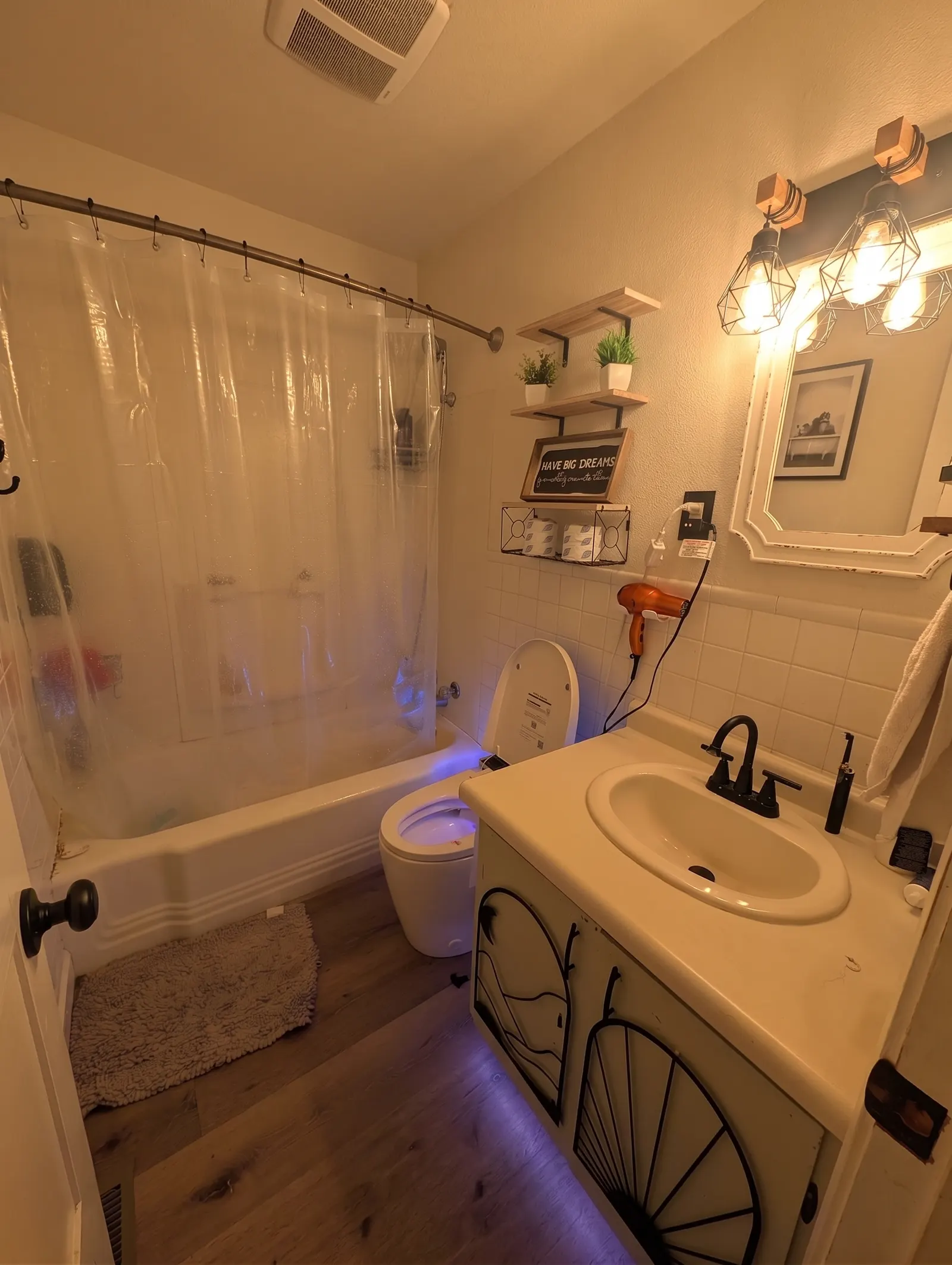 Full bathroom with a tub and shower, toilet, and vanity