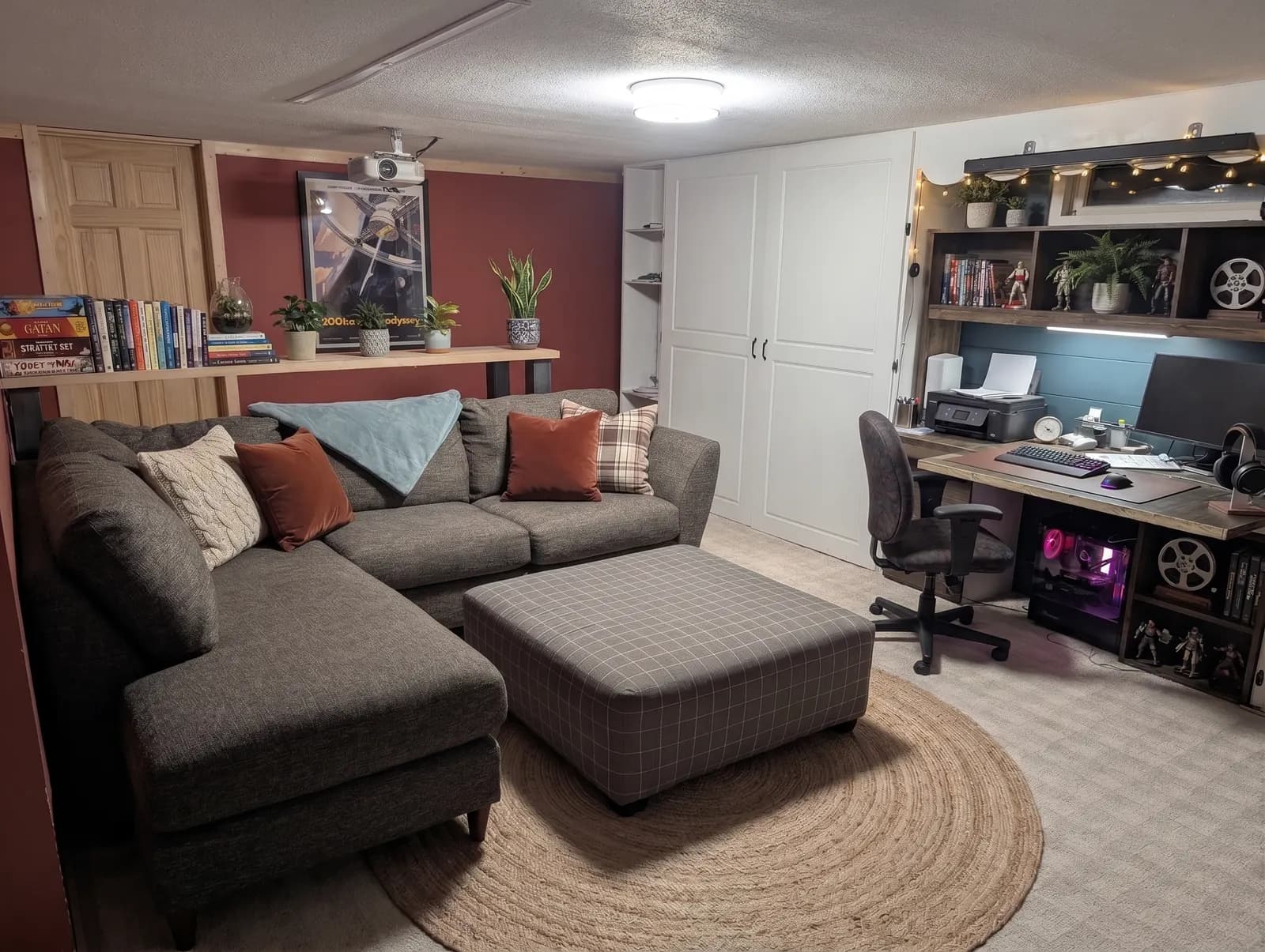 Lounge with a sectional couch, bookshelf, and a desk for schoolwork or job searching